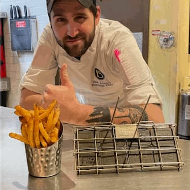 Chef giving thumbs up beside crispy fries and Frylow device