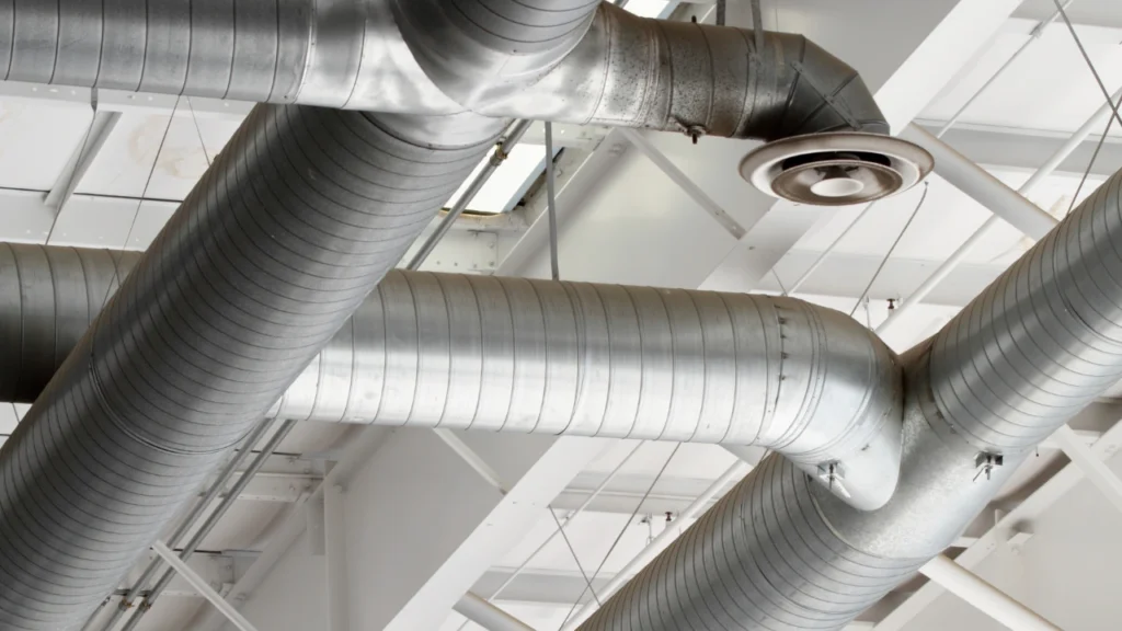 Stainless steel air filtration ducts in commercial kitchen.