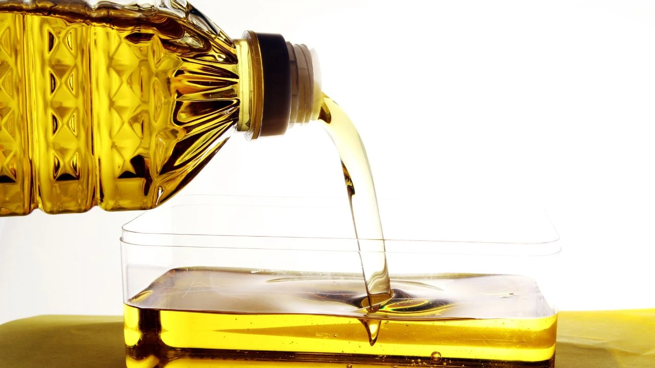 cooking oil pouring into a clear container
