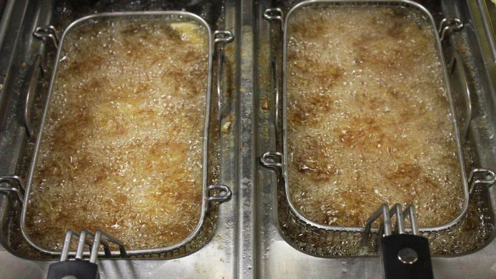 two deep fryer basket with bubbling oil