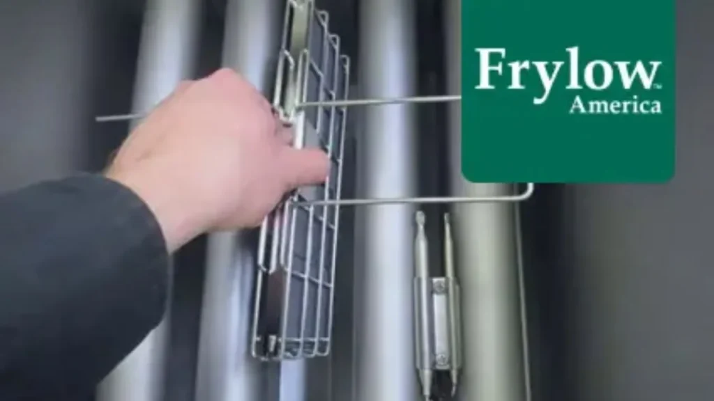 Hand installing Frylow device in a fryer system