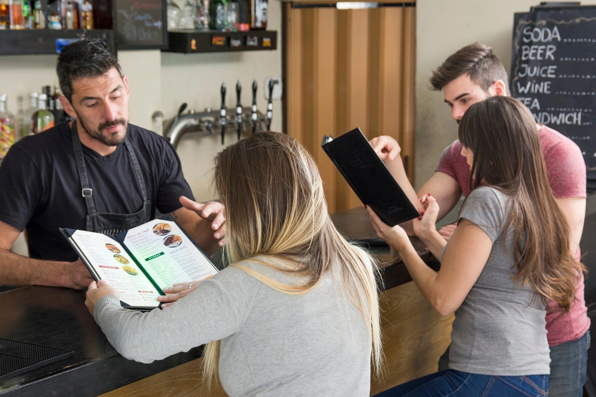 Group discussing menu options at restaurant counter
