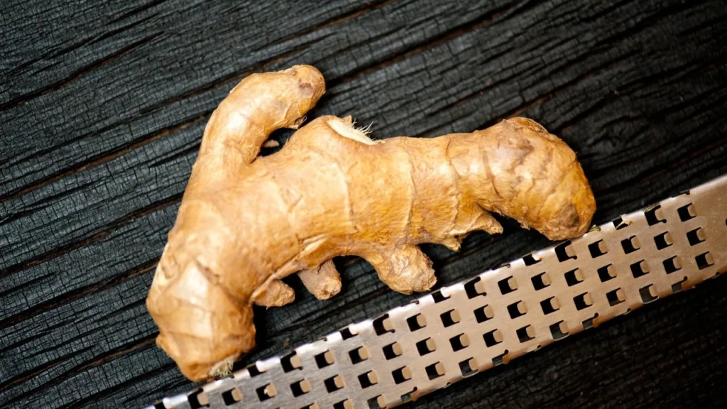 whole ginger root next to micro-grater
