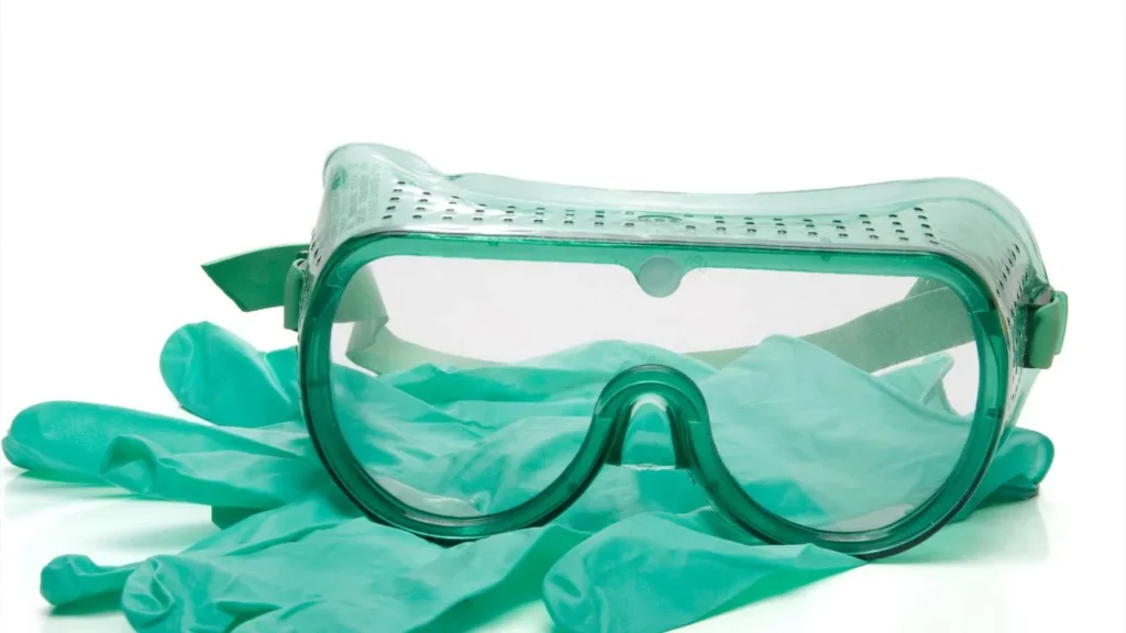Safety goggles and gloves for protective equipment use.