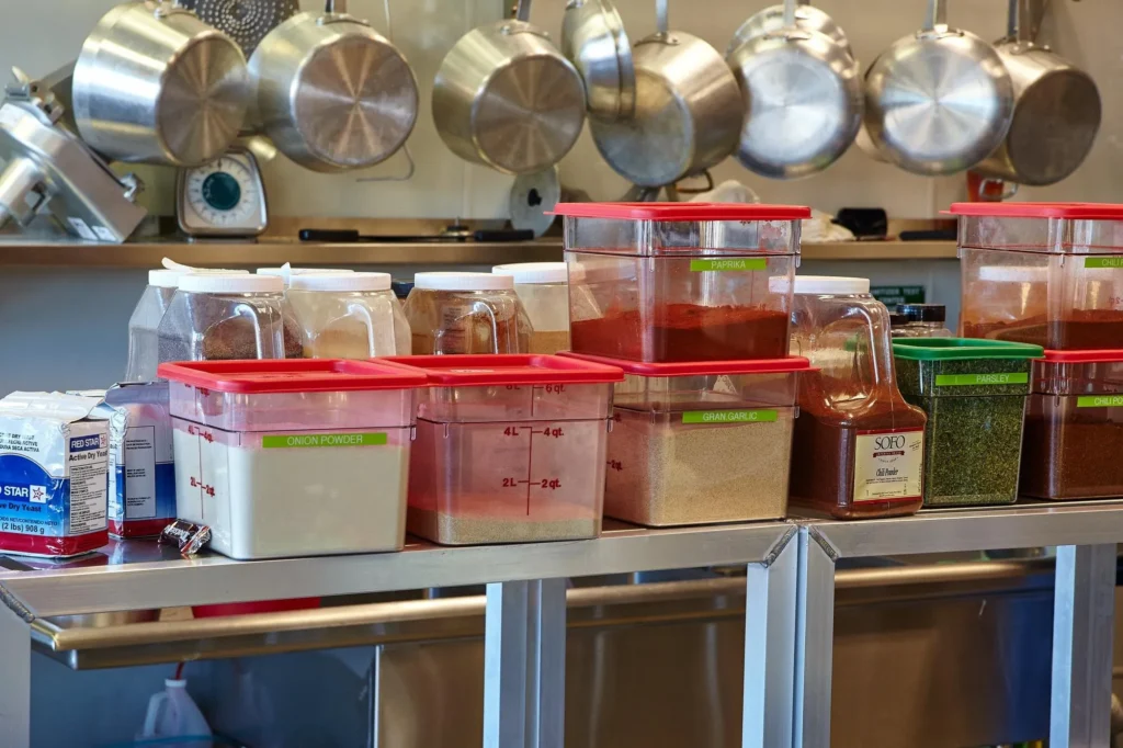 Clear restaurant food containers neatly labeled for storage.