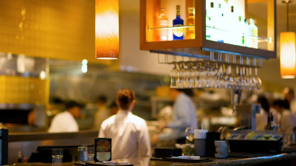 Restaurant bar with blurred kitchen staff in background