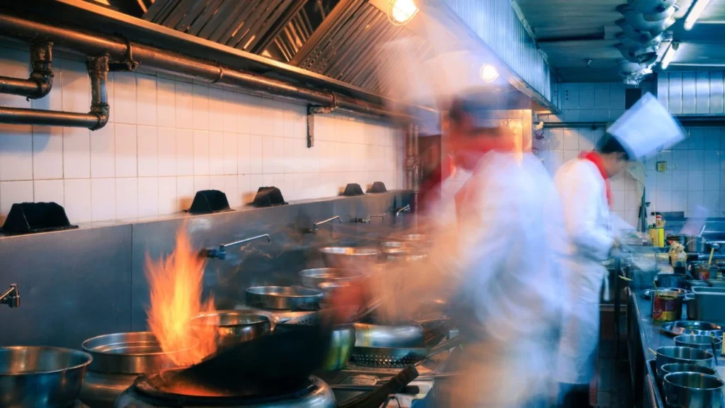 Interior of restaurant kitchen and busy chefs