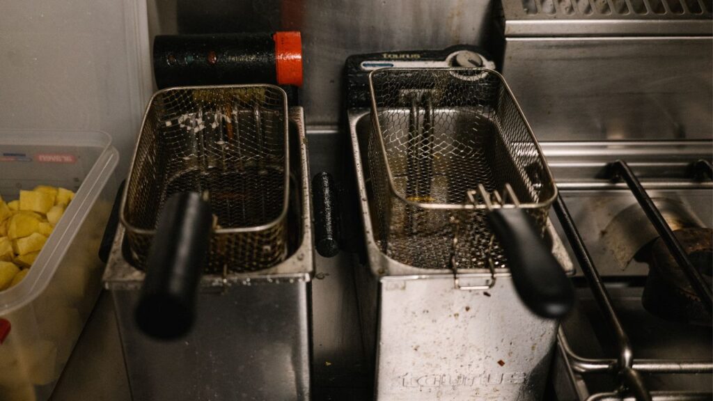 Commercial countertop deep fryer with frying baskets installed.