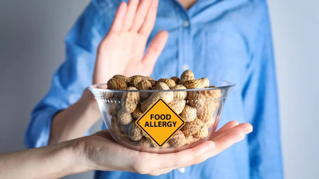 A person refusing to eat peanuts due to food allergy