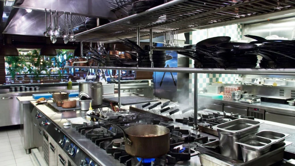 Industrial kitchen with stovetops, cookware, and organization