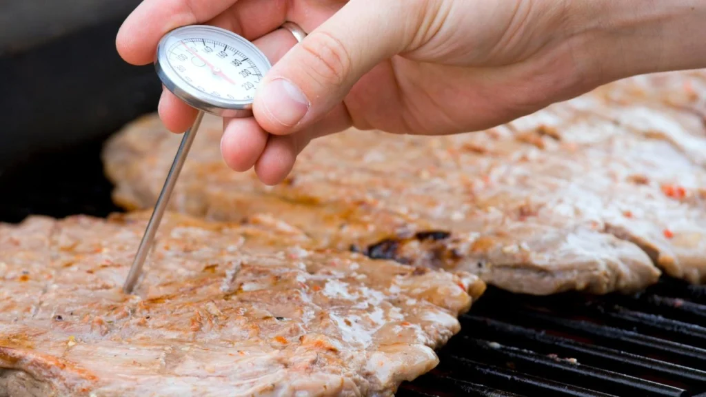 Checking meat temperature while grilling