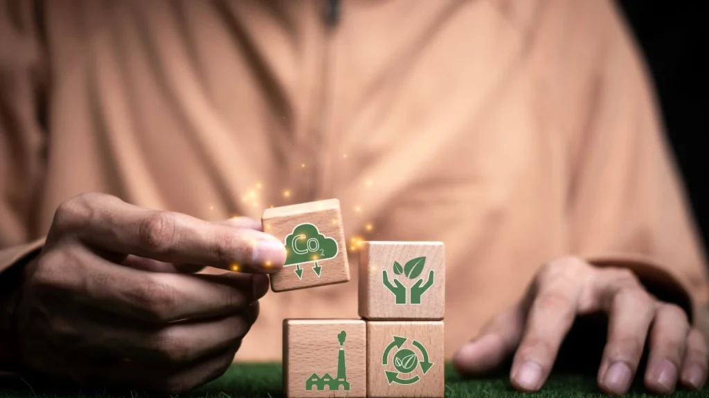 Man holding wooden blocks representing reduction of energy consumption