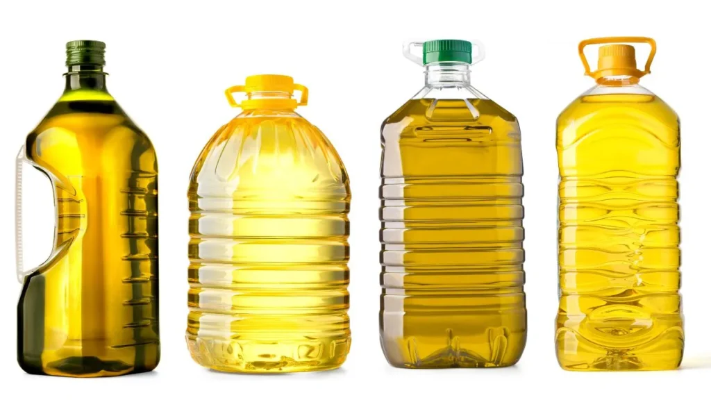 Big plastic bottles of oil on a white background