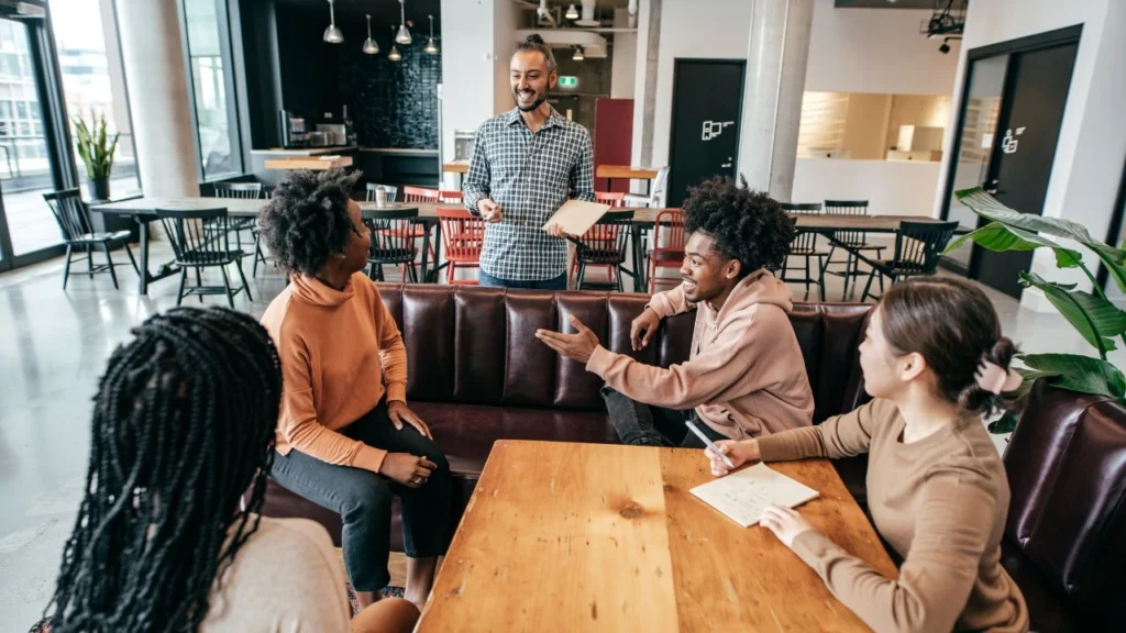 Restaurant staff in a casual training session with a manager.
