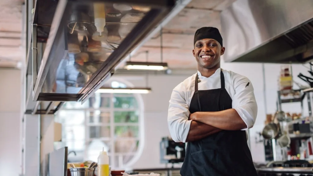 chef with arms crossed in restaurant kitchen