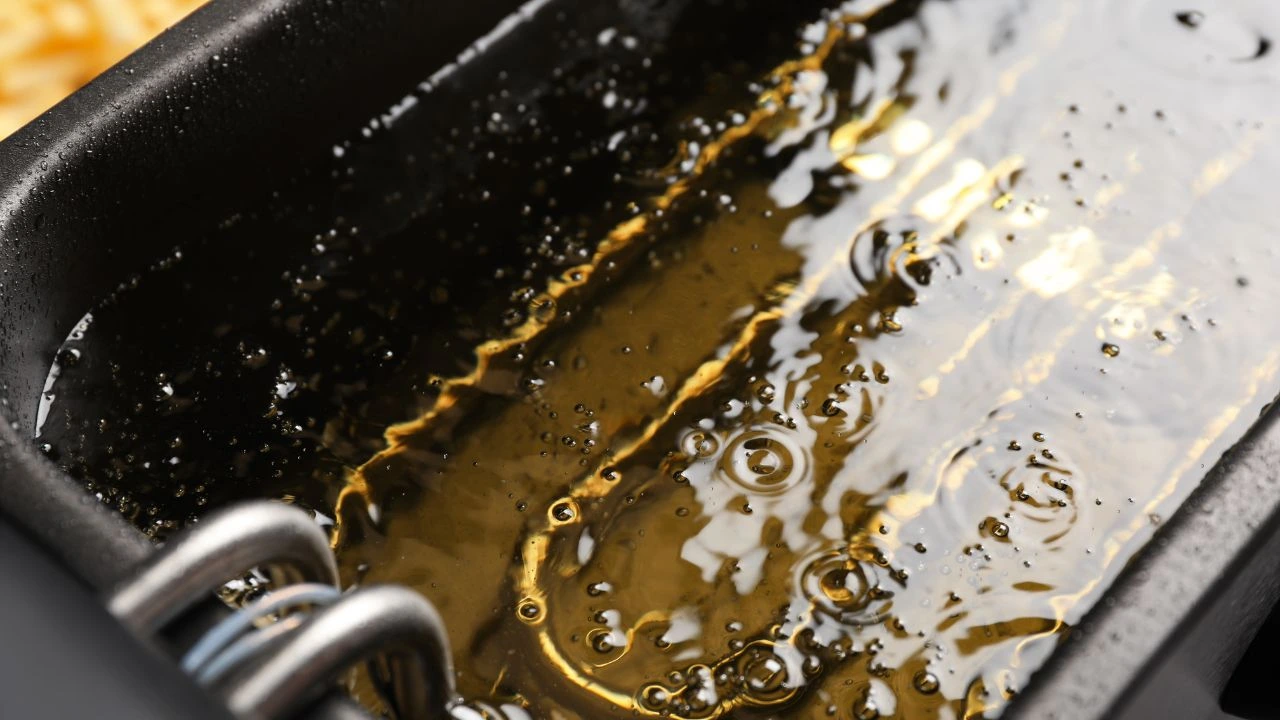 Frying oil in a fryer with bubbles and darkening signs