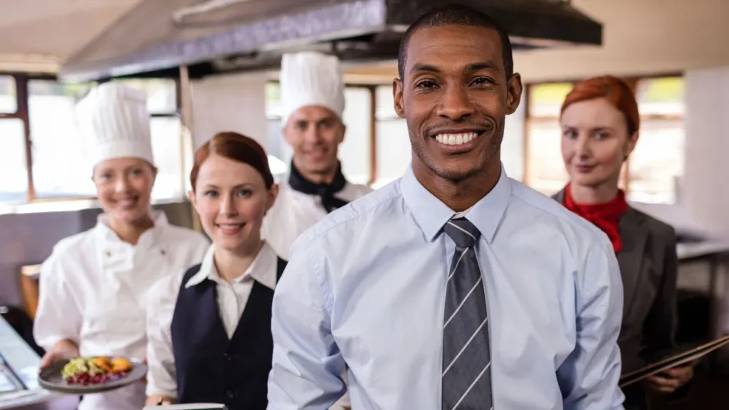 Restaurant staff smiling, representing Frylow training and kitchen efficiency