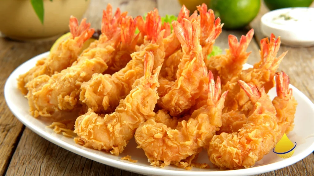 Plate of crispy golden fried shrimp on a white dish.