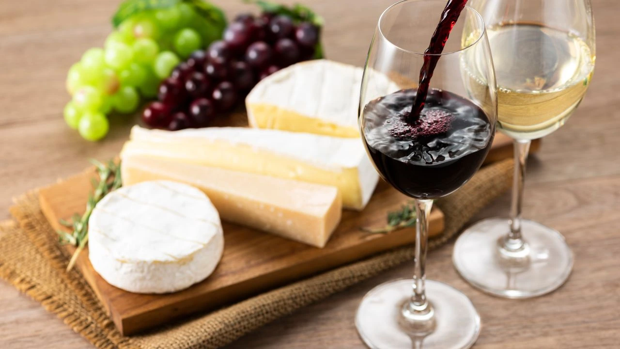 Assorted cheese wine and grapes