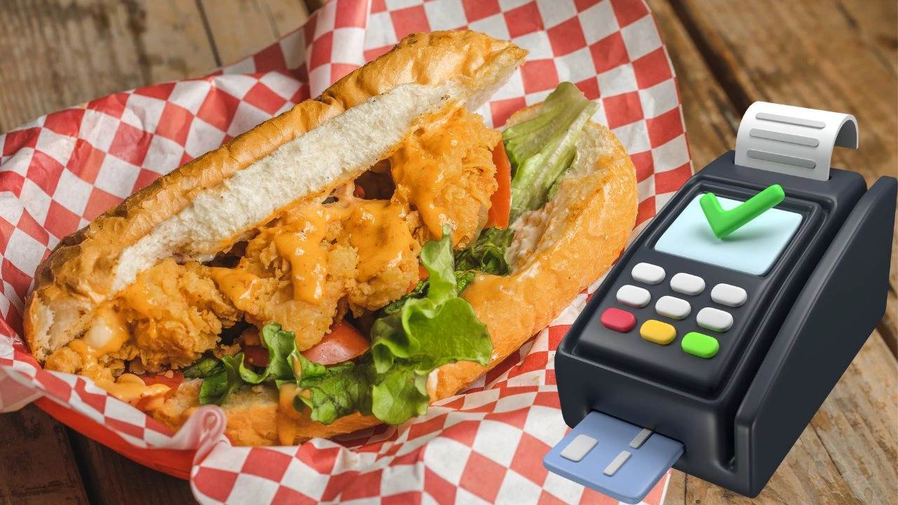 Fried chicken sandwich with lettuce and tomato next to a payment terminal, representing types of POS systems for food trucks.
