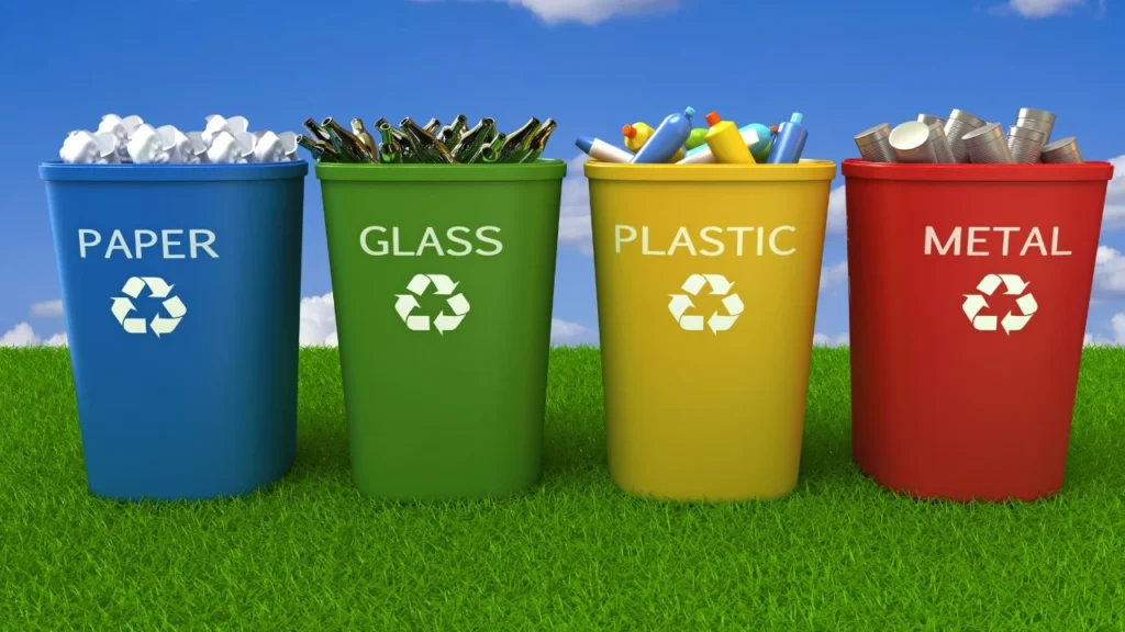Color-coded bins for recycling paper, glass, plastic, metal.