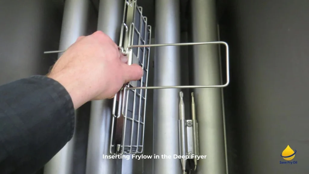 Chef inserting Frylow in commercial deep fryer
