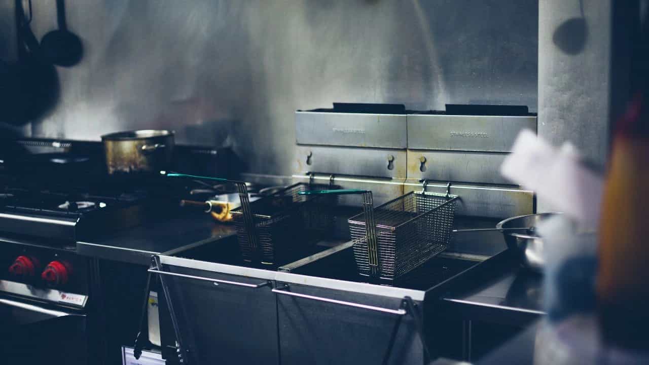 commercial kitchen with empty double deep fryer