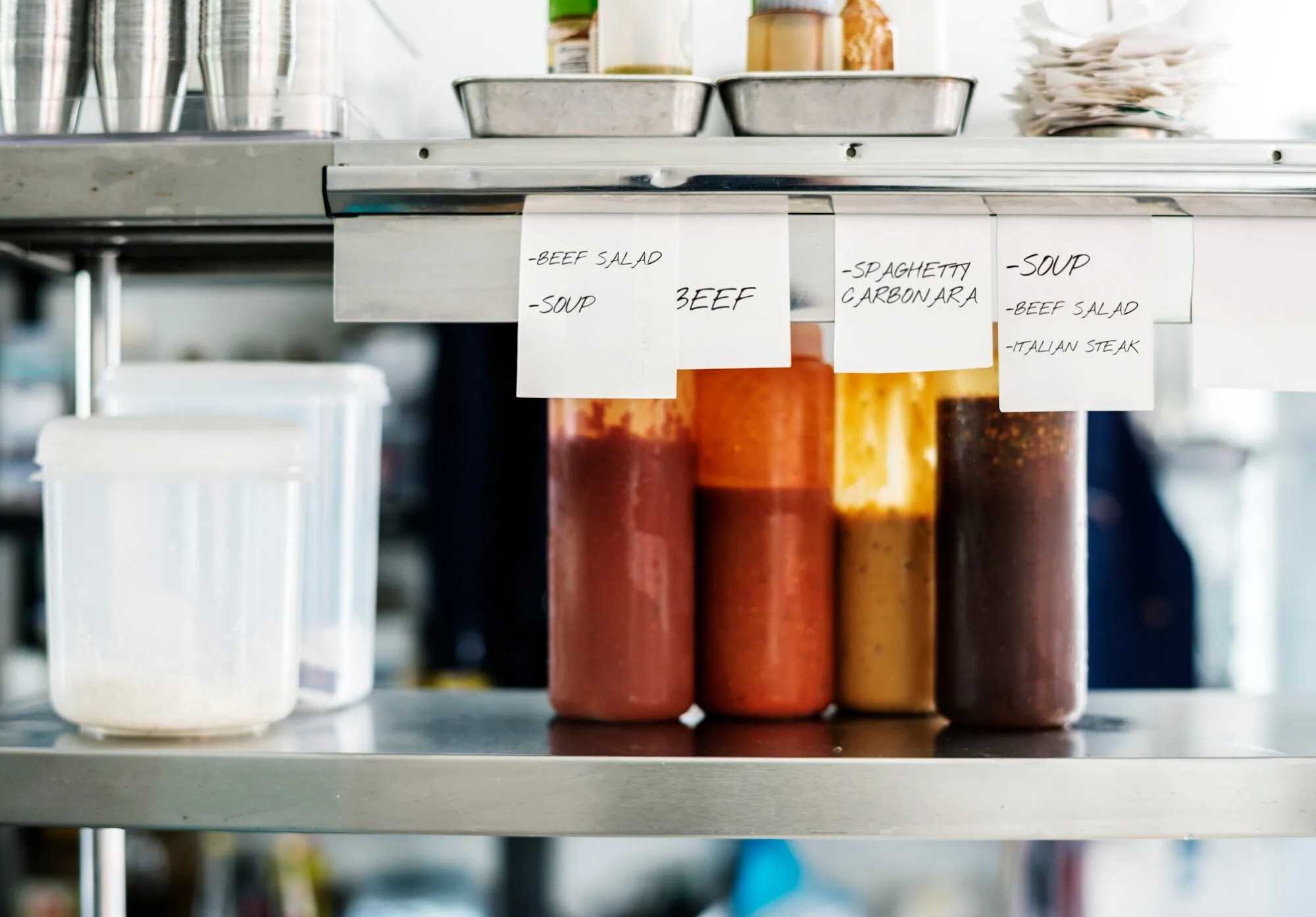 Organized storage containers in a commercial kitchen.