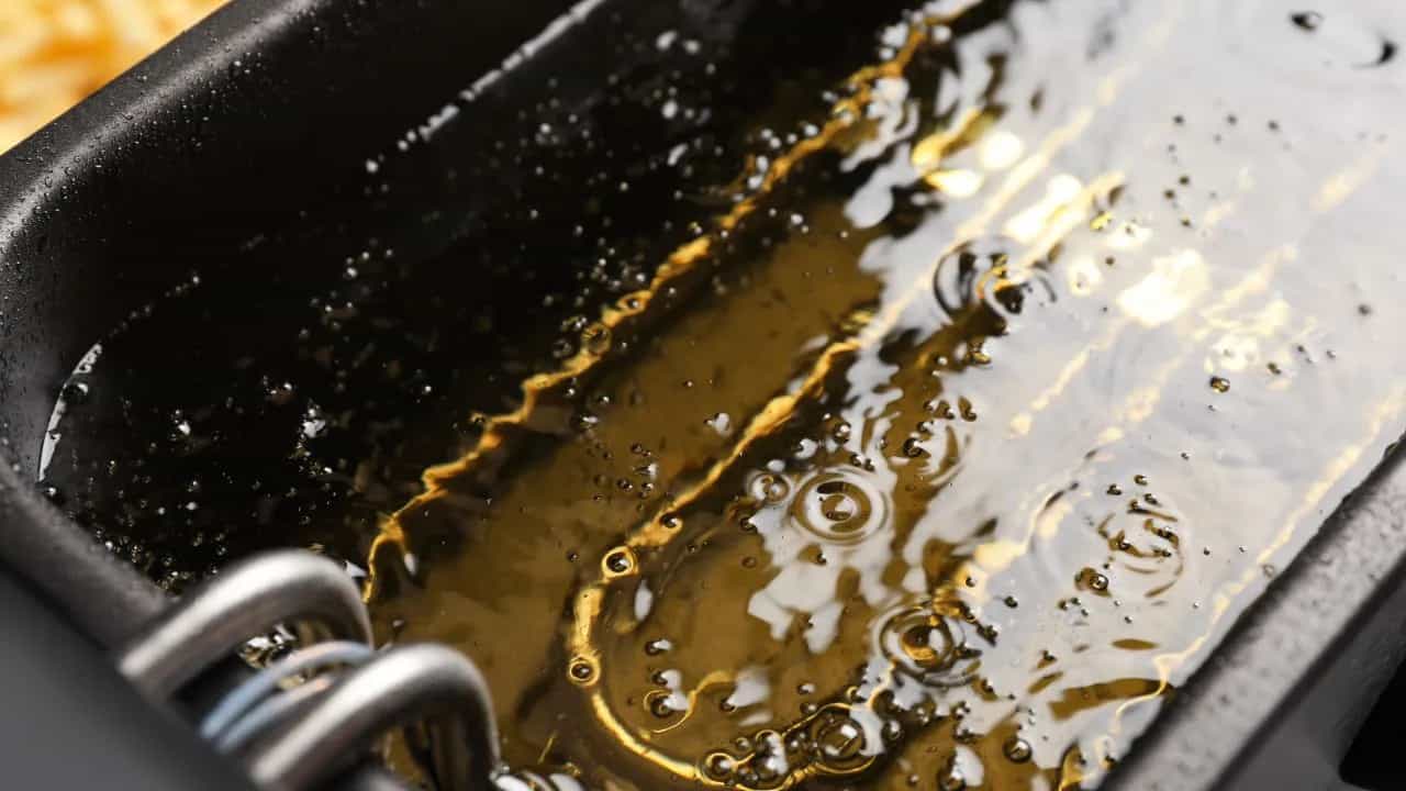 Close-up of bubbling oil in a fryer