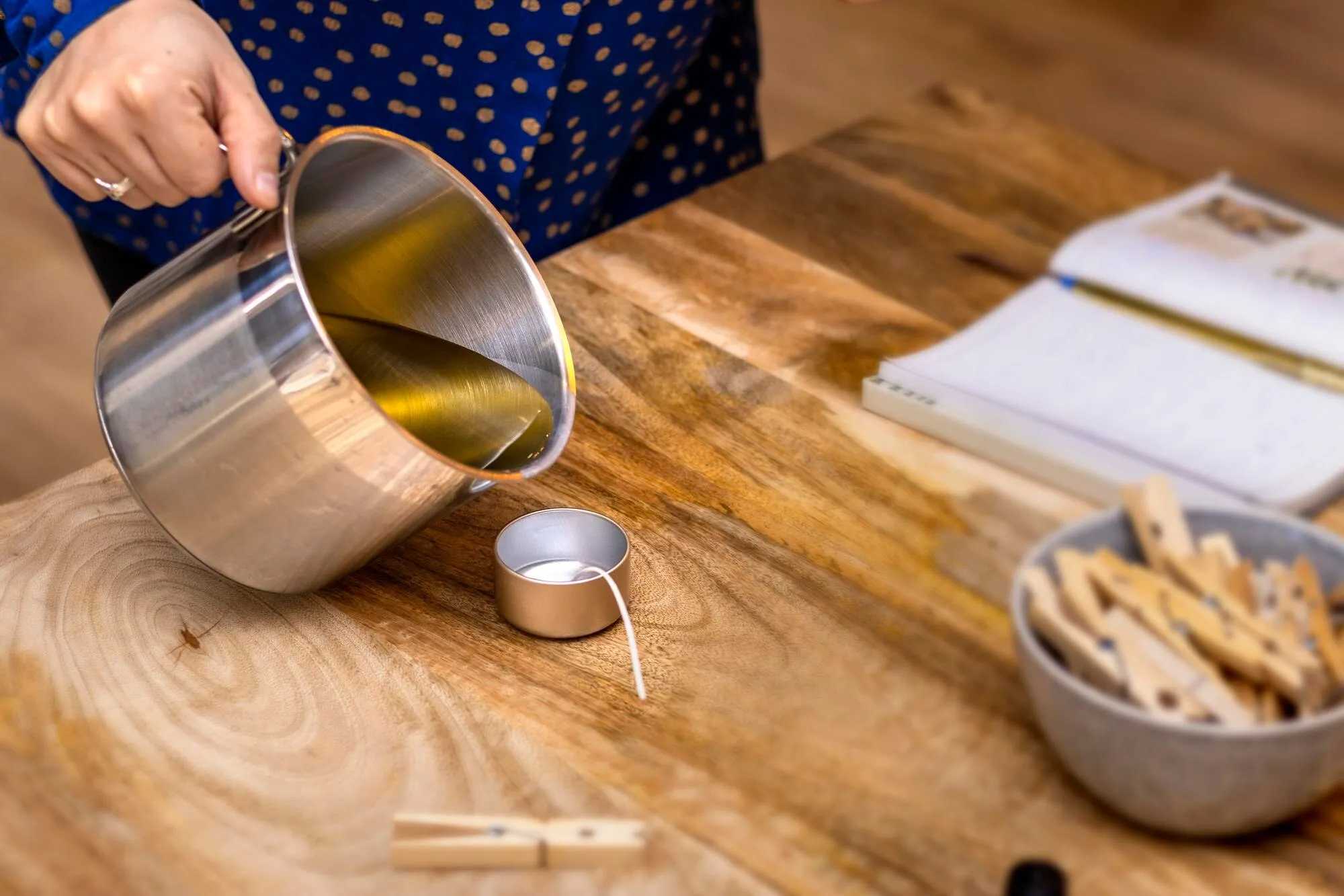 Chef pouring used cooking oil into a candle