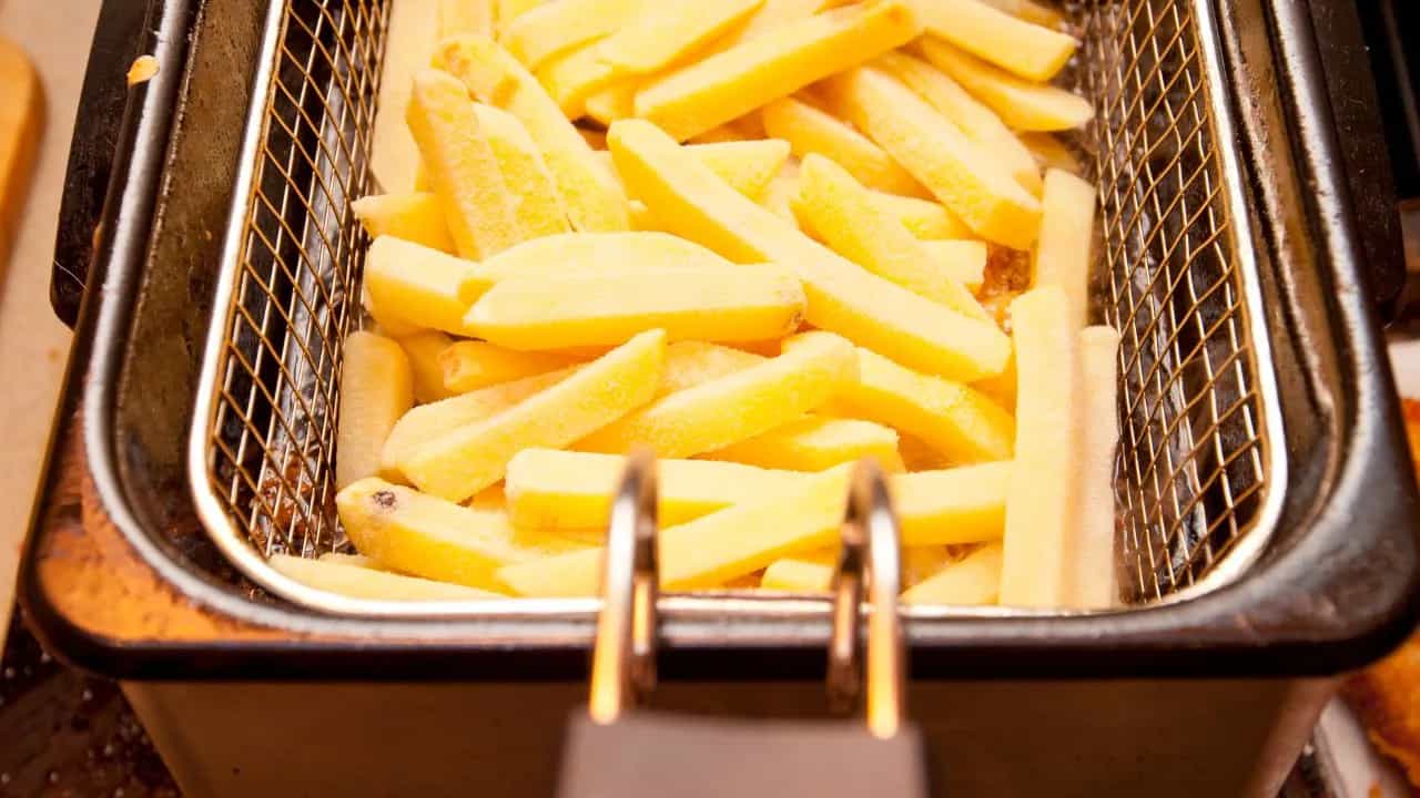 Frying french fries in a deep fryer basket