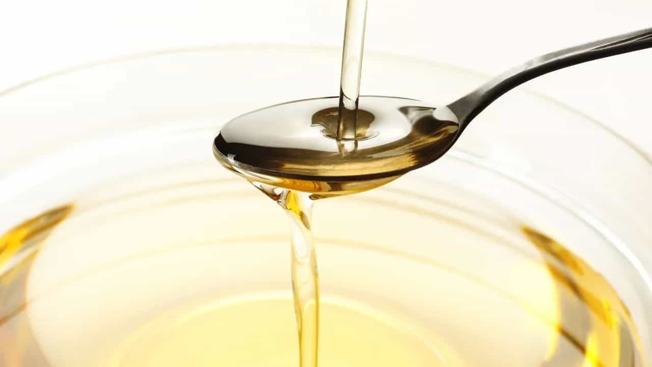 A bowl of cooking oil with a spoon