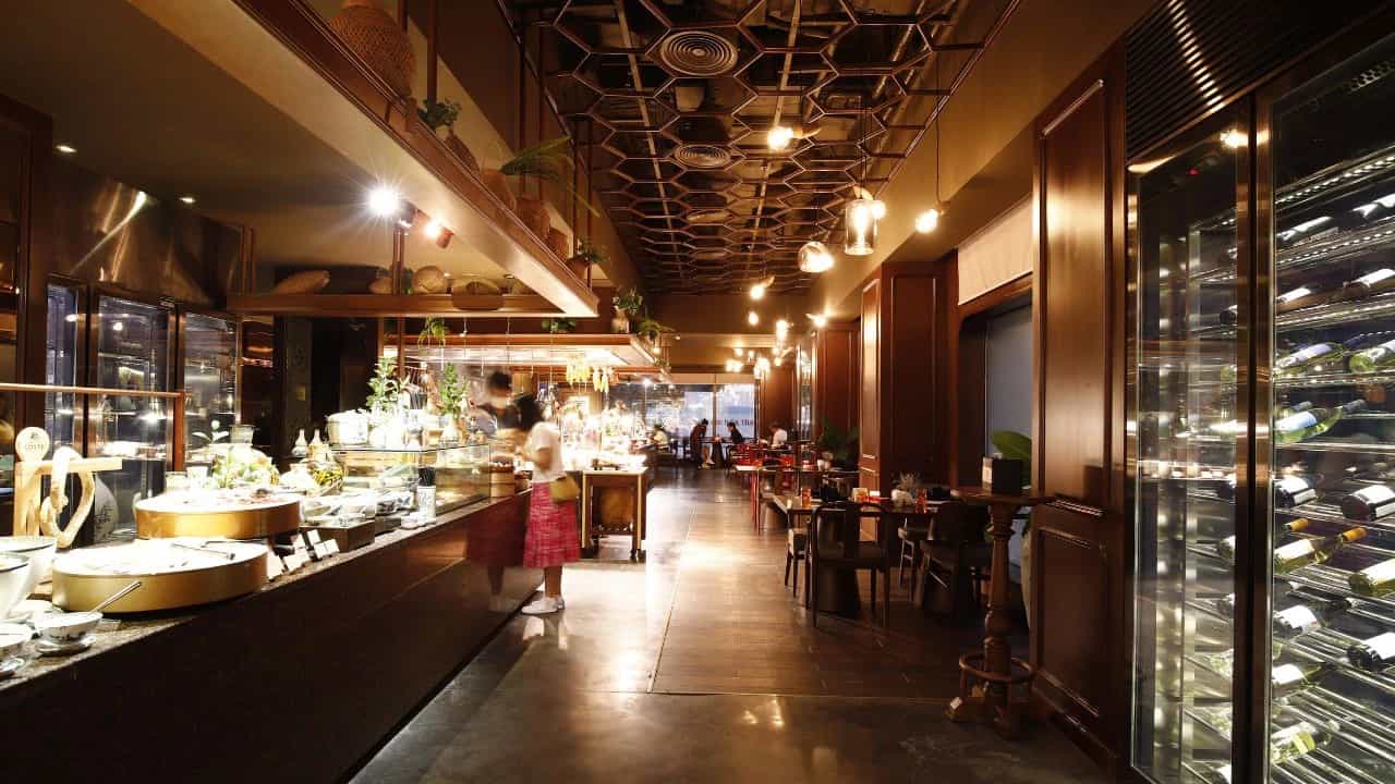 Elegant restaurant interior with buffet counter and wine display.