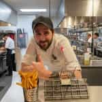 frylow case study: chef giving the thumbs up with serving of french fries next to frylow device